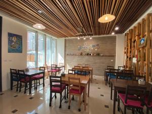 a dining room with wooden tables and chairs at 樂活小築民宿Lohas Taitung B&B in Taitung City