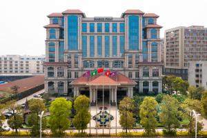 a large building with a gazebo in front of it at Marco Polo Jin Jiang in Jinjiang