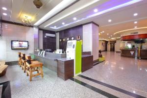 a lobby with a counter and chairs in a building at Chuan Fu Hotel in Fengyuan