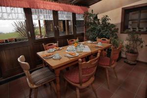 a wooden table and chairs in a room at Pension St. Georg mit Moststüberl in Bad Griesbach
