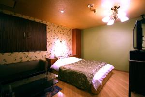 Postel nebo postele na pokoji v ubytování Hotel Ohirune Racco Higashiosaka ( Adult Only)