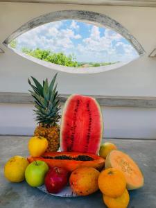 a plate of fruit on a table with a window at Villa Antilope in Cancún