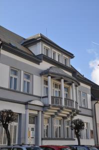 a large white building with columns at Apartmány vila Týniště in Týniště nad Orlicí