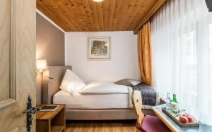 a small room with a bed and a window at Hotel Stern Chur in Chur +74 photos