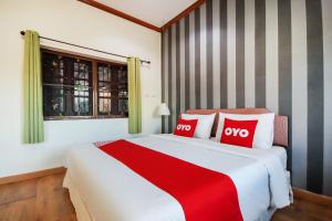Cama o camas de una habitación en OYO 1117 Phuket Airport Suites