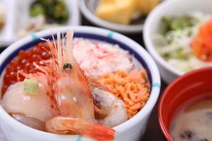 a bowl of food with a shrimp and rice at Hakodate Danshaku Club Hotel & Resorts in Hakodate