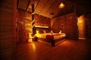 ein Schlafzimmer mit einem Bett in einem Zimmer mit Holzwänden in der Unterkunft Green Trees Munnar in Munnar