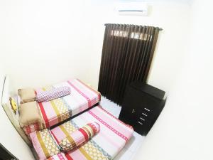a group of blankets sitting on a shelf in a room at Minggiran Street Homestay jogja in Yogyakarta