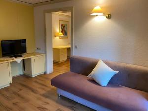 a living room with a couch with a pillow on it at Hotel Belmont in Imst