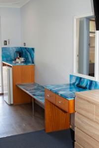 a kitchen with a blue counter top in a room at Manjimup Motor Inn in Manjimup