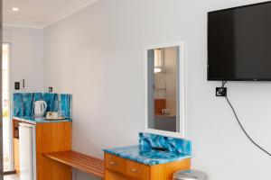 a living room with a tv on a wall at Manjimup Motor Inn in Manjimup