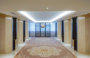 a hallway with a large carpet in a building at Guangdong Hotel in Guangzhou