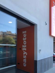 a sign in front of a building at easyHotel Malaga City Centre in Málaga