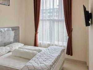 Voodi või voodid majutusasutuse Wisma Talenta Mitra RedDoorz toas