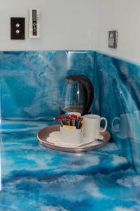 a cup of coffee in a blue and white bathtub at Manjimup Motor Inn in Manjimup