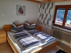 a bed with two pillows on it in a room at Ferienwohnung Kern in Finkenberg