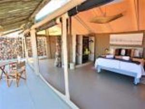 a living room with a bed and a couch at Elegant Desert Camp in Sesriem