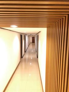 a hallway of a building with wooden walls and a long corridor at At Bangkok Hotel in Bangkok