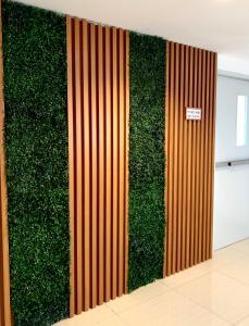 a green wall covered in plants in a building at At Bangkok Hotel in Bangkok