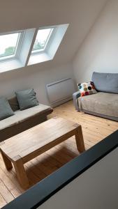 a living room with two beds and a wooden table at Belle Malouine in Saint Malo