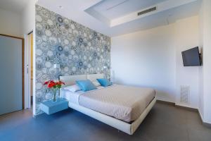 ein Schlafzimmer mit einem Bett und einer Wand mit Tellern in der Unterkunft Villa Ariele in Sorrent