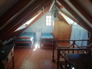 a attic room with two beds and a window at Madel's Traum in Rhodes