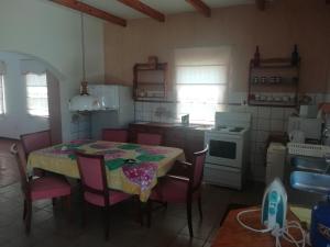 a kitchen with a table and chairs and a kitchen with a stove at Madel's Traum in Rhodes