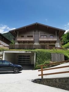 a car parked in front of a house at Chalet Marille Gastein in Bad Gastein