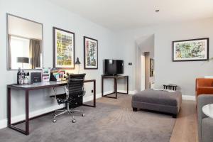 a living room filled with furniture and a tv at Malmaison Edinburgh in Edinburgh