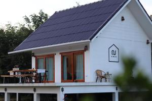 a house with solar panels on the roof at Cher_homeofrest in Ban Mai Na Hi