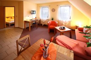 a living room with a couch and a table at Hotel-Pension zum Markt in Torgau