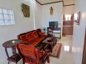 a living room with a couch and a table at Perlies Inn Balcony House in Tanay