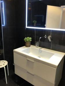a bathroom with a white sink and a mirror at Hotel Jadran in Split