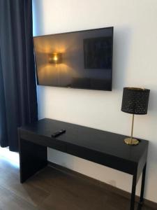 a black desk with a television on a wall at Hotel Jadran in Split