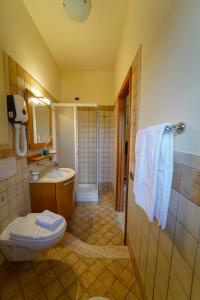 a bathroom with a toilet and a sink at La Bussola Hotel Calabria in Capo Vaticano