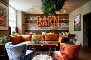 a bar with a couch and a sign that reads bar at Artist Residence Cornwall in Penzance