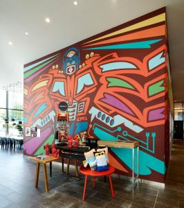a wall with a colorful mural in a room at citizenM Seattle South Lake Union in Seattle