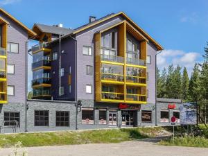 an apartment building with yellow and gray at Holiday Home Levin kunkku c11 by Interhome in Sirkka