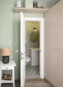 a bathroom with a toilet and a sink at Anna Green House in Palanga