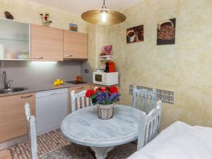 a small kitchen with a table with flowers on it at Apartment Coto Gamo Holiday Escape by Interhome in Pals