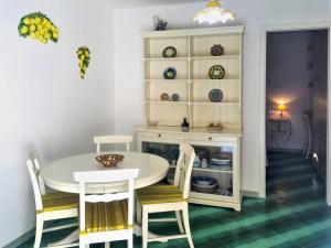 a dining room with a white table and chairs at Apartment Casale di Torca by Interhome in Torca