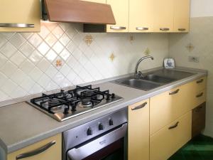 a kitchen with a stove and a sink at Apartment Casale di Torca by Interhome in Torca