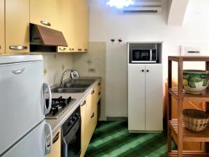 a small kitchen with a sink and a refrigerator at Apartment Casale di Torca by Interhome in Torca
