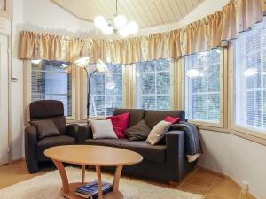 a living room with a couch and a table at Holiday Home Tähti b by Interhome in Syöte
