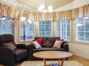 a living room with a couch and a table at Holiday Home Tähti b by Interhome in Syöte