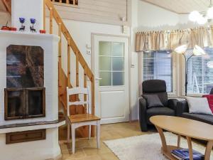 a living room with a fireplace and a couch at Holiday Home Tähti b by Interhome in Syöte +13 photos