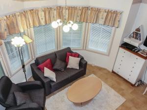 a living room with a couch and a table at Holiday Home Tähti b by Interhome in Syöte