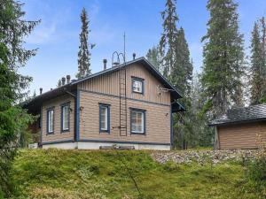 a house on top of a hill with trees at Holiday Home Tähti b by Interhome in Syöte