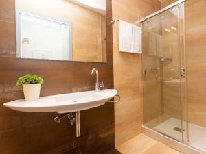 a bathroom with a sink and a shower at Apartment Centro- Passeig de Gracia - Casa Batllo by Interhome in Barcelona