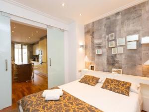a bedroom with a bed and a wall with pictures at Apartment Centro- Passeig de Gracia - Casa Batllo by Interhome in Barcelona